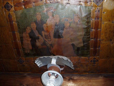 The cabin ceiling, with painted oil cloth pictures set into the birch bark.