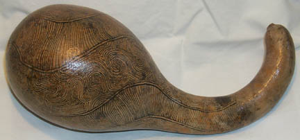 A dried gourd with intricate fine lines drawn on it.