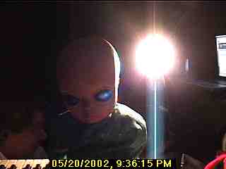 Photo: Alien facing you with bright light coming over his left shoulder.