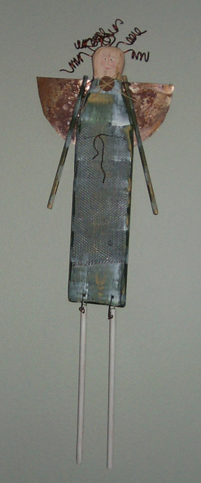Sculpture: Angel, by Linda Kozak Nash, a wooden angel with metal hair and wings, and wooden arms and legs.  Copyright &copy; 1998, Linda Kozak Nash.